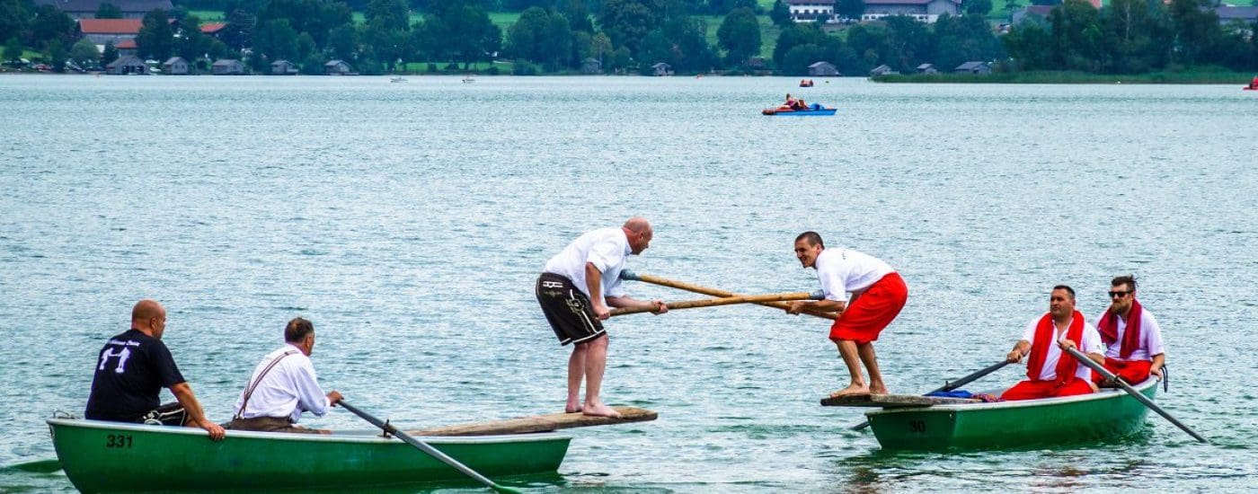 Schliersee, Germany - July 28: Bavarian competition of two groups with rowboats at a summer festival called Fishermen Joust in Schliersee, germany on July 28, 2018