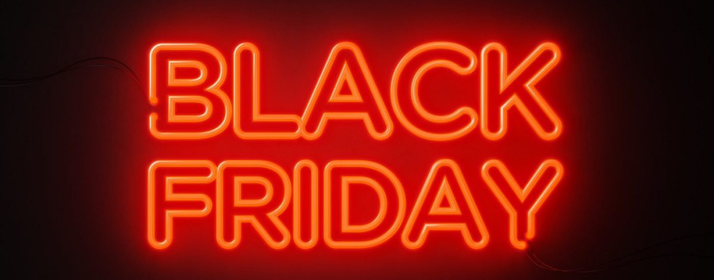 Black Friday red neon light on black wall. Horizontal composition with copy space. Black Friday concept.